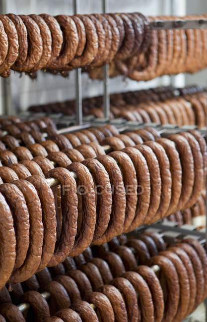 Sausages hanging in smoke house — Stock Photo