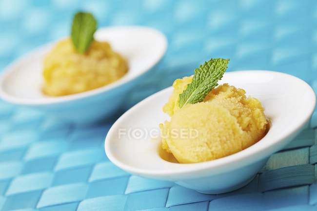 Scoops of home-made mango sorbet — Stock Photo