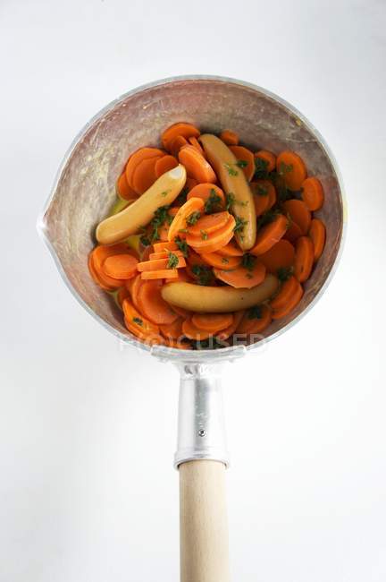 Carrots with parsley and sausages — Stock Photo