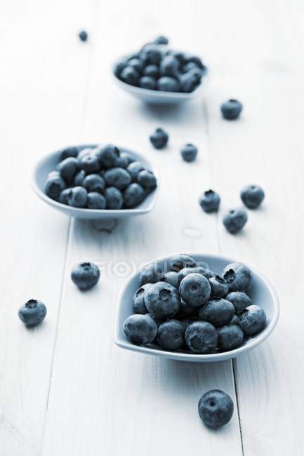Three small bowls of blueberries — Stock Photo