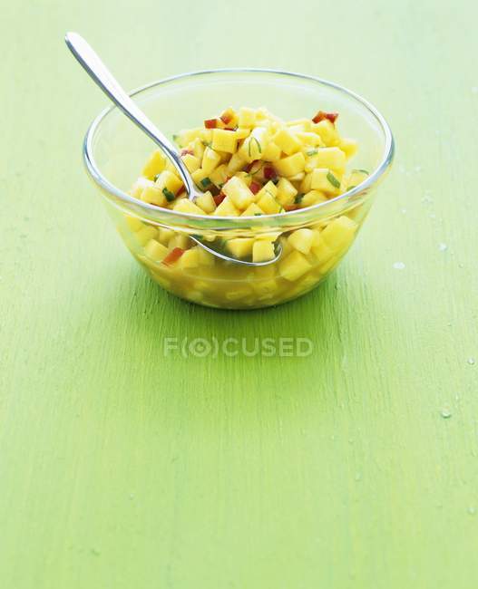 Closeup view of mango salsa in a glass bowl — Stock Photo