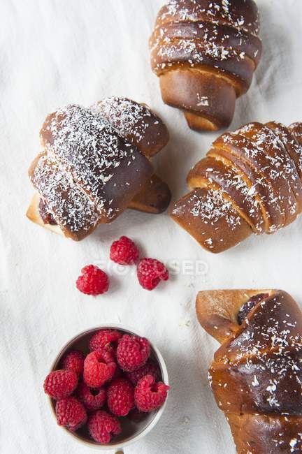 Chocolate croissants with raspberries — Stock Photo