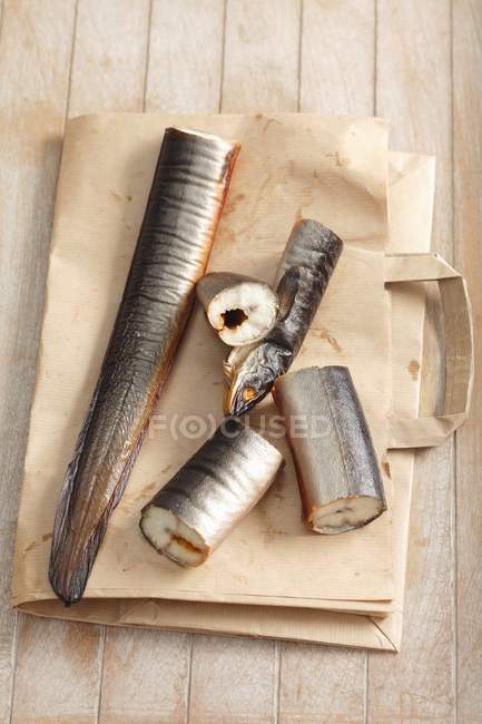 Smoked eel on paper bag — Stock Photo