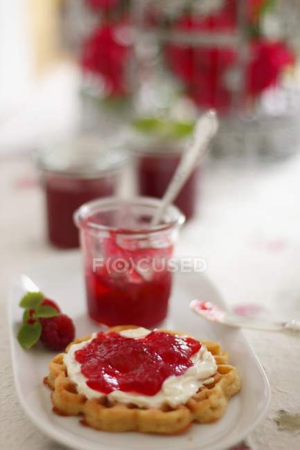 Waffle topped with raspberry and rose jam — Stock Photo