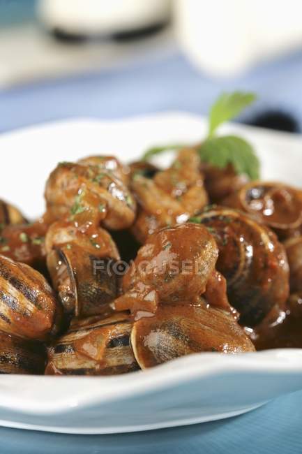 Hot and sweet snails  on white plate — Stock Photo