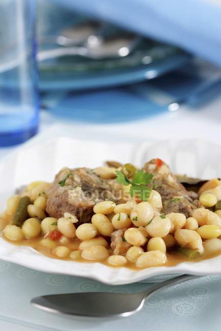 Pork cheeks with stewed beans — Stock Photo