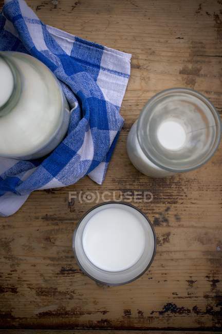 Milk in bottle and glass — Stock Photo