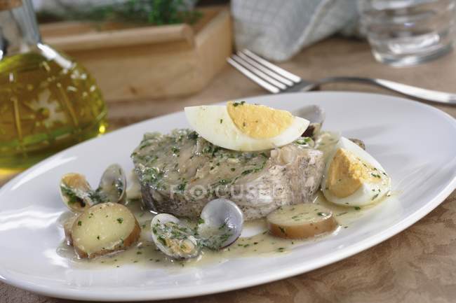 Hake and chips koskera on white plate over table — Stock Photo