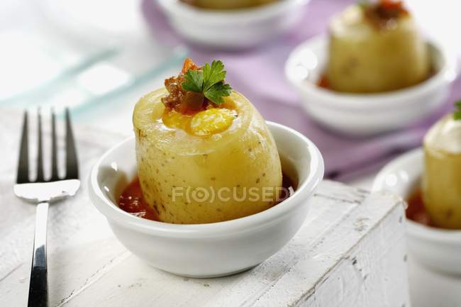 Egg wth potato and herbs in small bowl over wooden surface — Stock Photo
