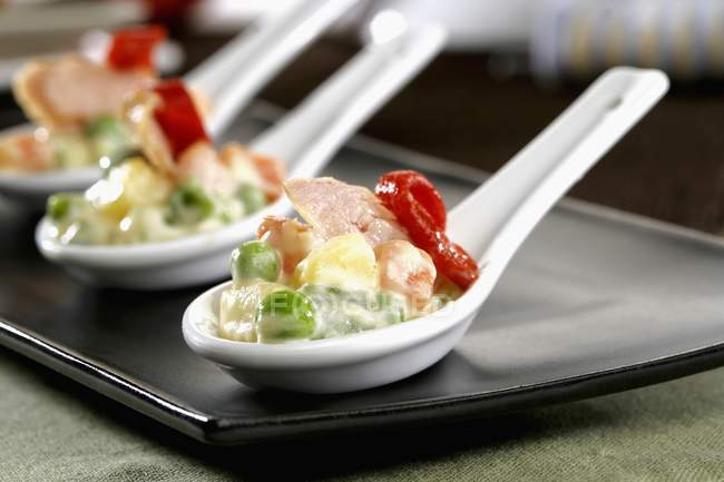 Russian salad spoons on plate — Stock Photo