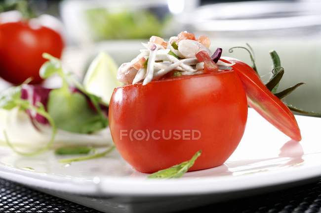 Tomatoes filled with seafood salad — Stock Photo