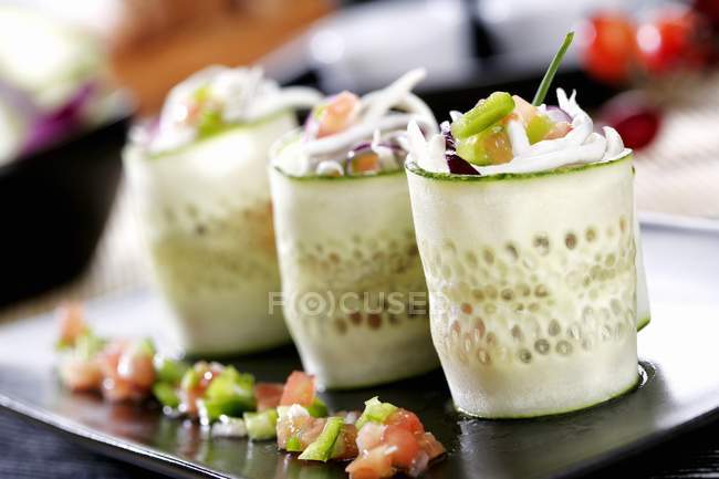 Rolled cucumber strips filled with seafood — Stock Photo