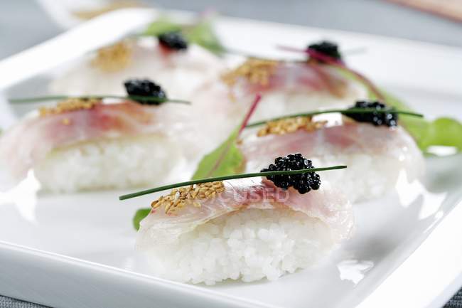 Bream nigiri sushi with black caviar — Stock Photo