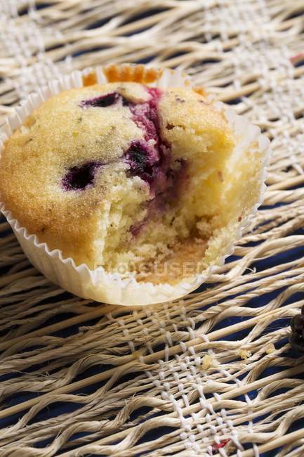 Berry muffin in baking parchment — Stock Photo
