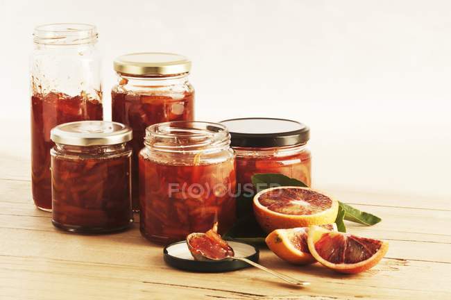 Closeup view of several jars of blood orange and Campari marmalade — Stock Photo