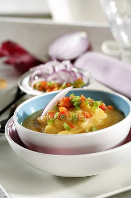 Houmous with diced vegetables in white bowls — Stock Photo