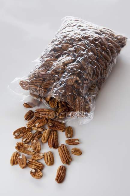 Pecan nuts spilling out — Stock Photo