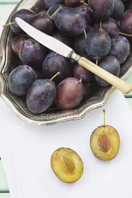 Plums in silver bowl — Stock Photo