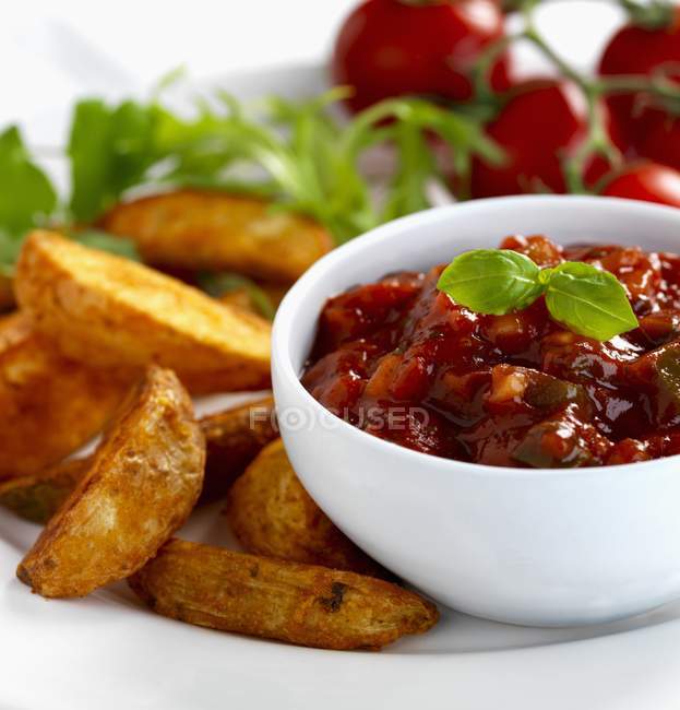 Salsa dip with roasted potato wedges — Stock Photo