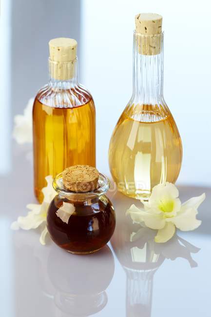 Vista close-up de garrafas de vidro com flores de orquídea — Fotografia de Stock