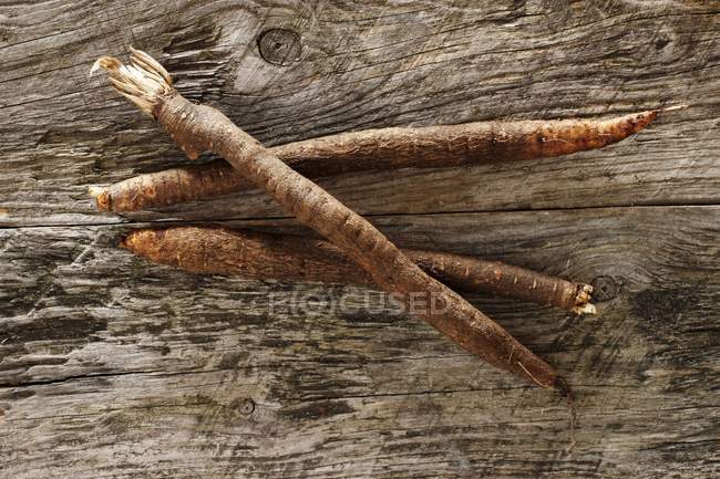 Black salsify on a rustic wooden table — Stock Photo