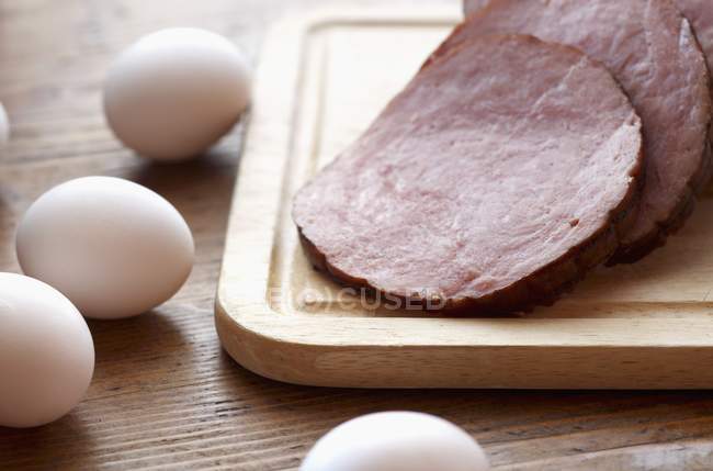 Fresh Eggs and sliced Ham — Stock Photo
