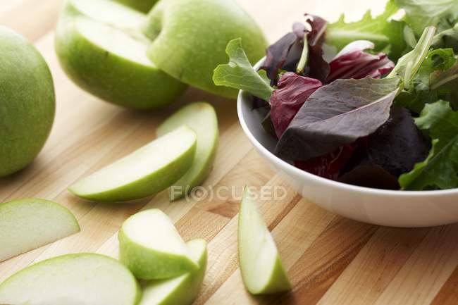 Manzana verde en rodajas y verduras mixtas - foto de stock