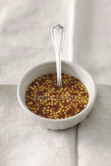 Coarse-grained mustard in bowl — Stock Photo