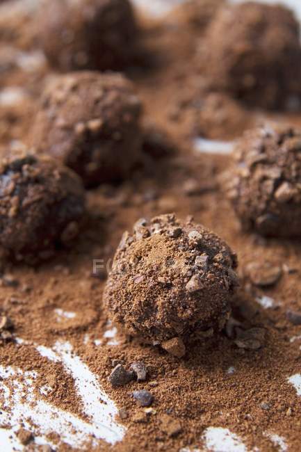 Closeup view of truffles with cocoa nibs — Stock Photo