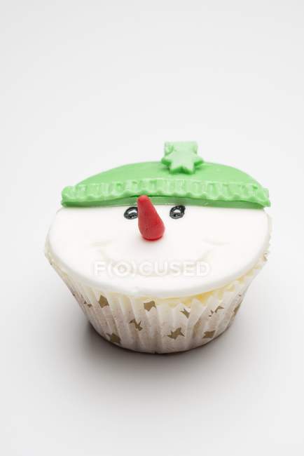 Cupcake decorated like snowman — Stock Photo