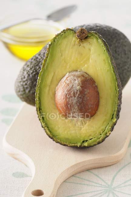 Fresh avocado with half — Stock Photo