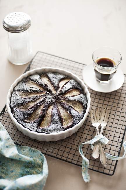 Closeup view of chocolate and pear tart with a glass of coffee — Stock Photo
