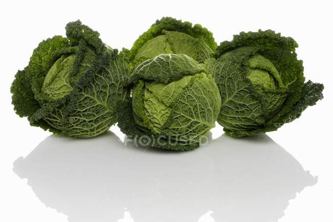 Four fresh savoy cabbages — Stock Photo