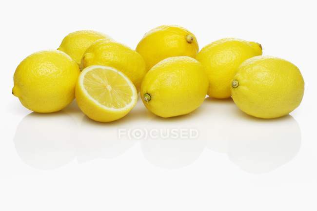 Fresh ripe lemons with half — Stock Photo