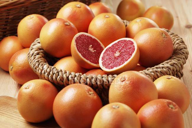 Pink grapefruits with basket — Stock Photo