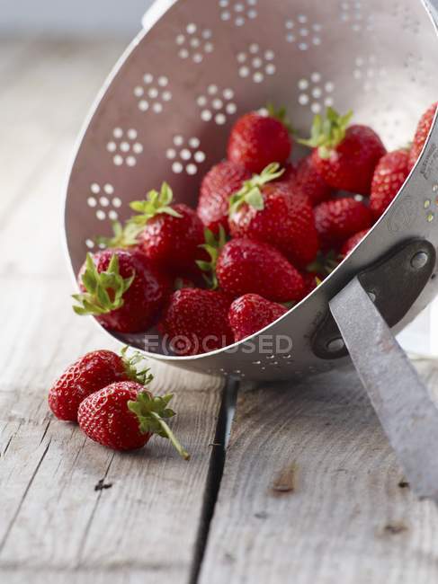 Fresh strawberries in colander — Stock Photo