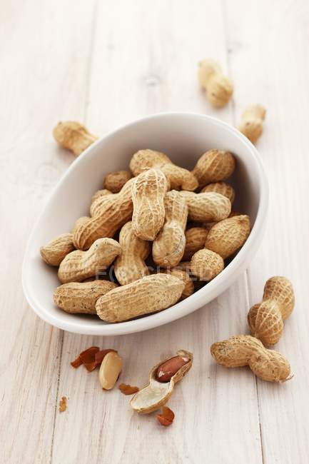 Peanuts in white bowl — Stock Photo