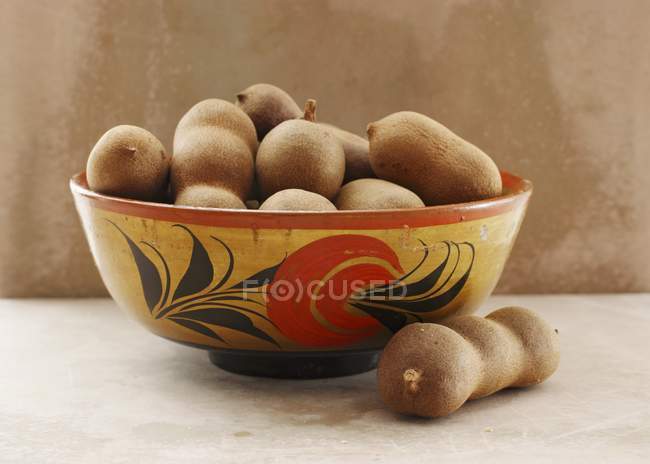 Tamarinds in rustic bowl — Stock Photo