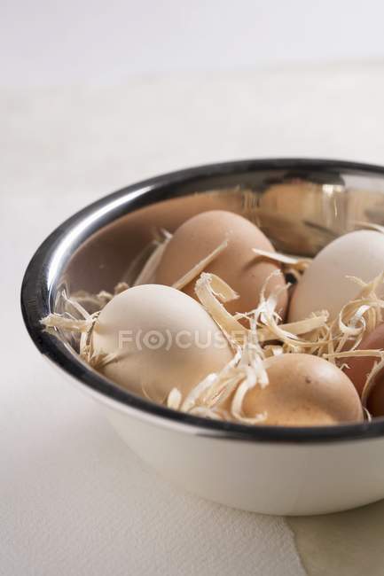 Fresh eggs with straw — Stock Photo