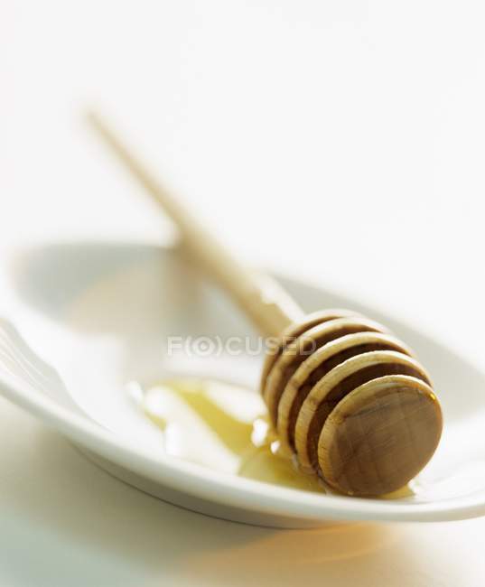 Plate with wooden dipper — Stock Photo