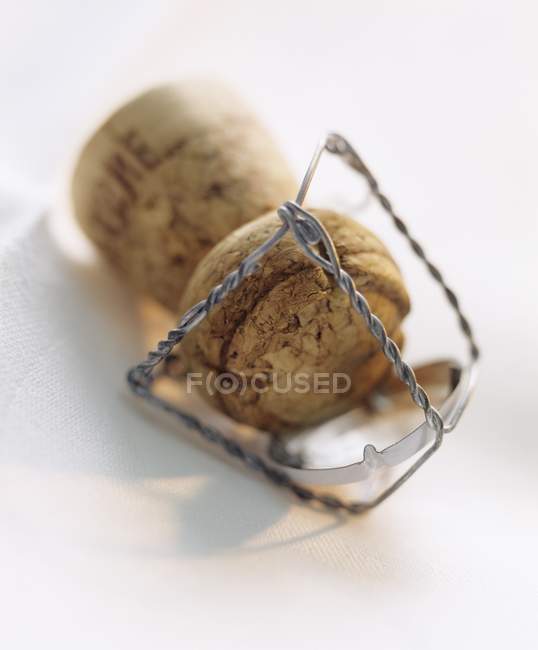 Closeup view of one bottle cork with wire on white surface — Stock Photo