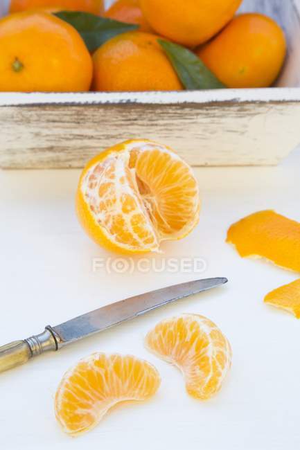Peeled Clementine with knife — Stock Photo