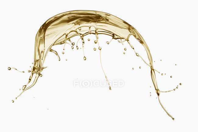 Primo piano vista di una spruzzata di olio su sfondo bianco — Foto stock