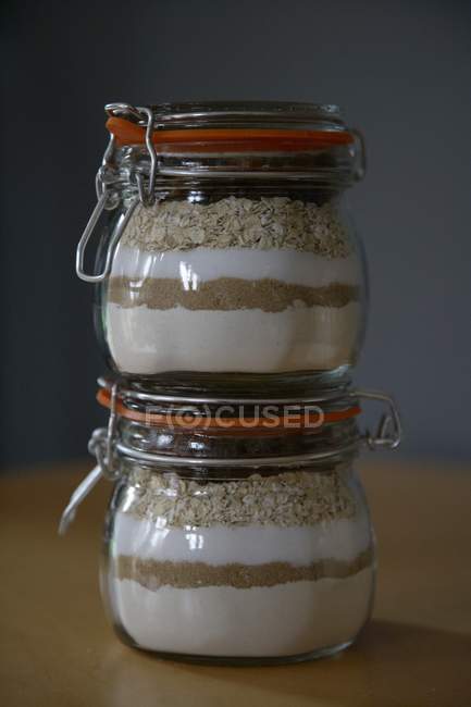 Closeup view of oatmeal raisin cookie mix in preserving jars — Stock Photo