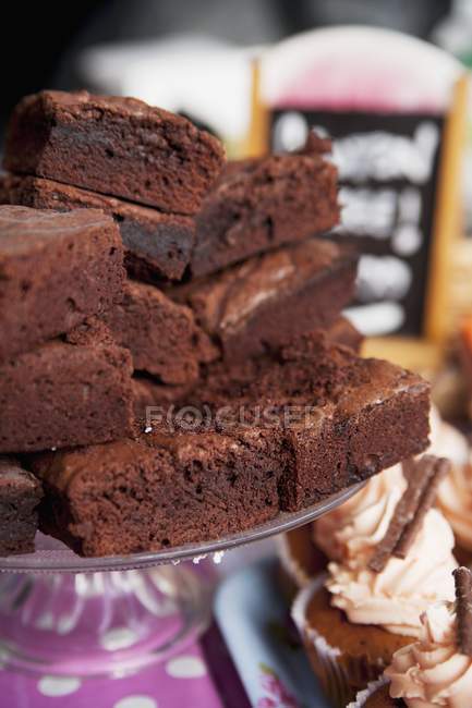 Stacked brownies on cake stand — Stock Photo