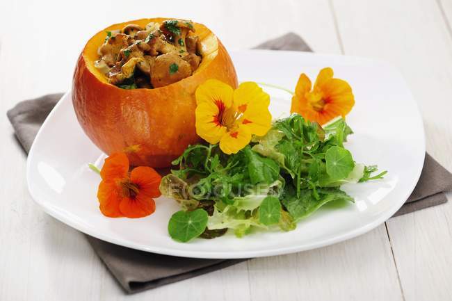 Fried Chantarelles in pumpkin with salad — Stock Photo