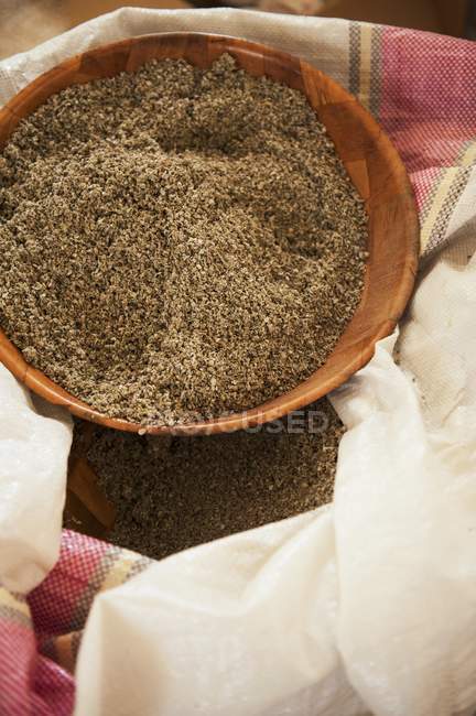 Top view of dried thyme in wooden a bowl on a sack — Stock Photo