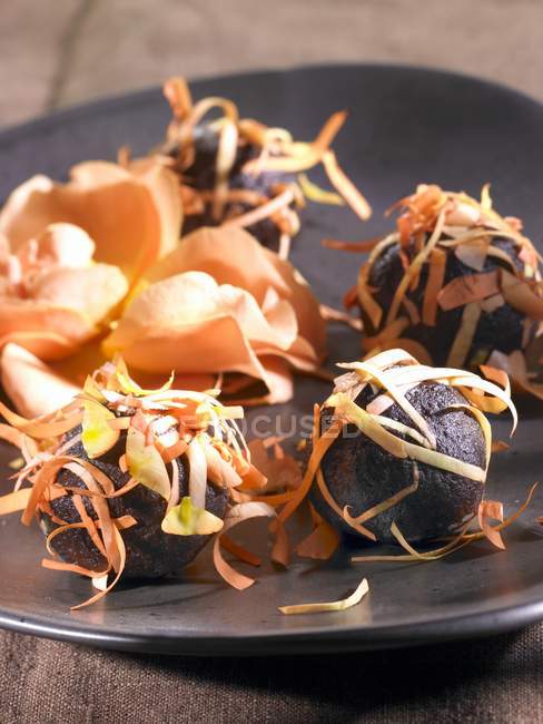 Closeup view of chocolate balls with rose petals — Stock Photo