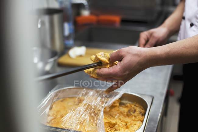 Cropped view of chef skewering Tandoori chicken — Stock Photo