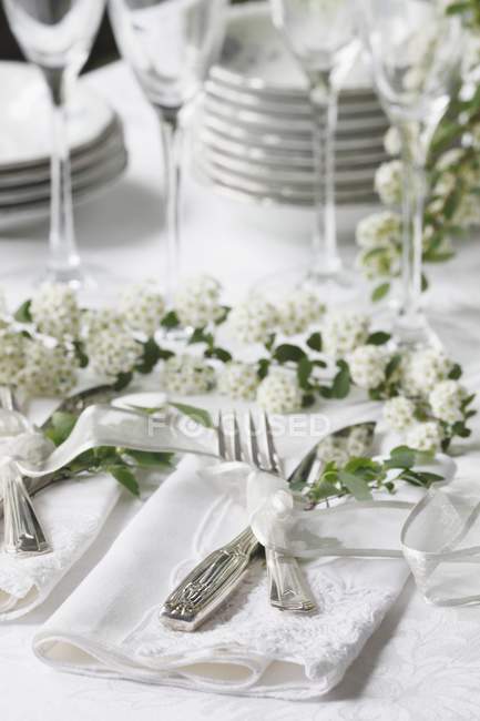 Elevated view of flatware setting with flowers on table — Stock Photo